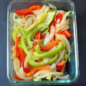 cooked fajita vegetables in glass dish