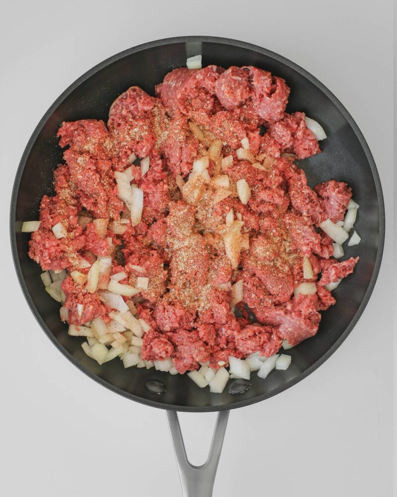 ground beef, onion, and seasoning in a skillet.