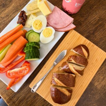snacky lunch on platters on table.