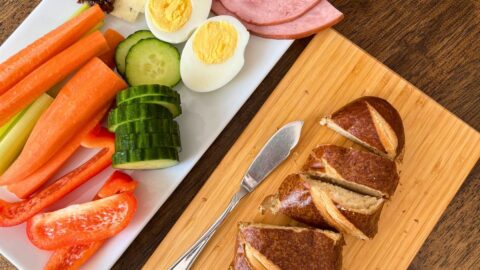 snacky lunch on platters on table.