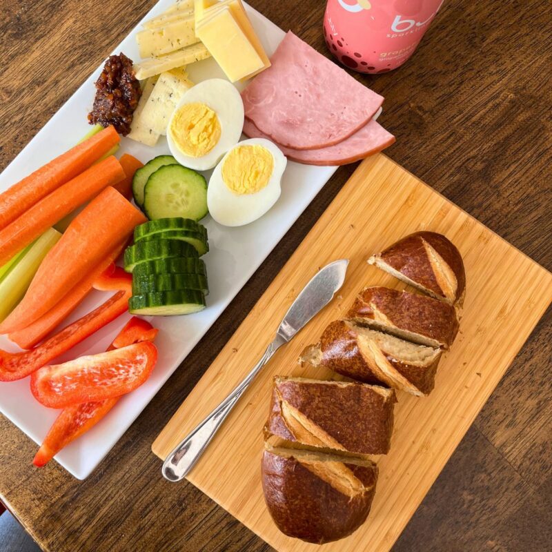 snacky lunch on platters on table.