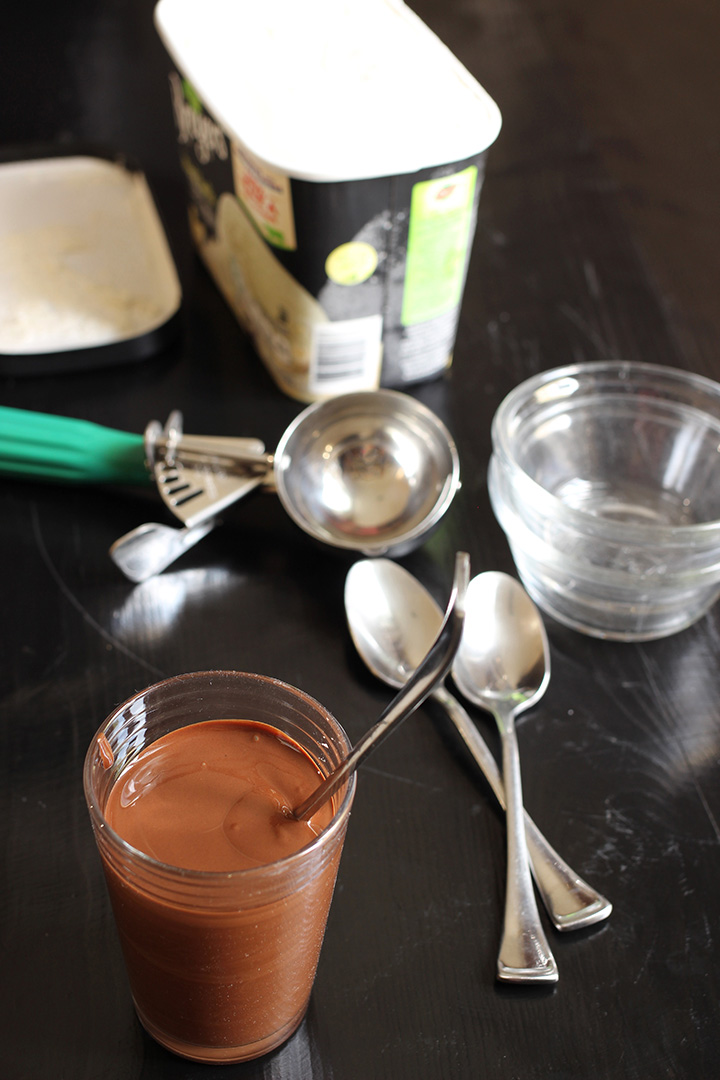 melted magic shell in glass with spoon and sundae ingredients