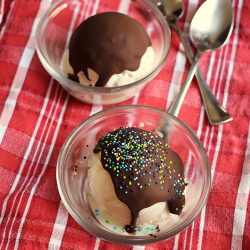 two bowls of scooped ice cream with magic shell and sprinkles