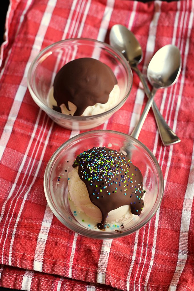 two bowls of scooped ice cream with magic shell and sprinkles