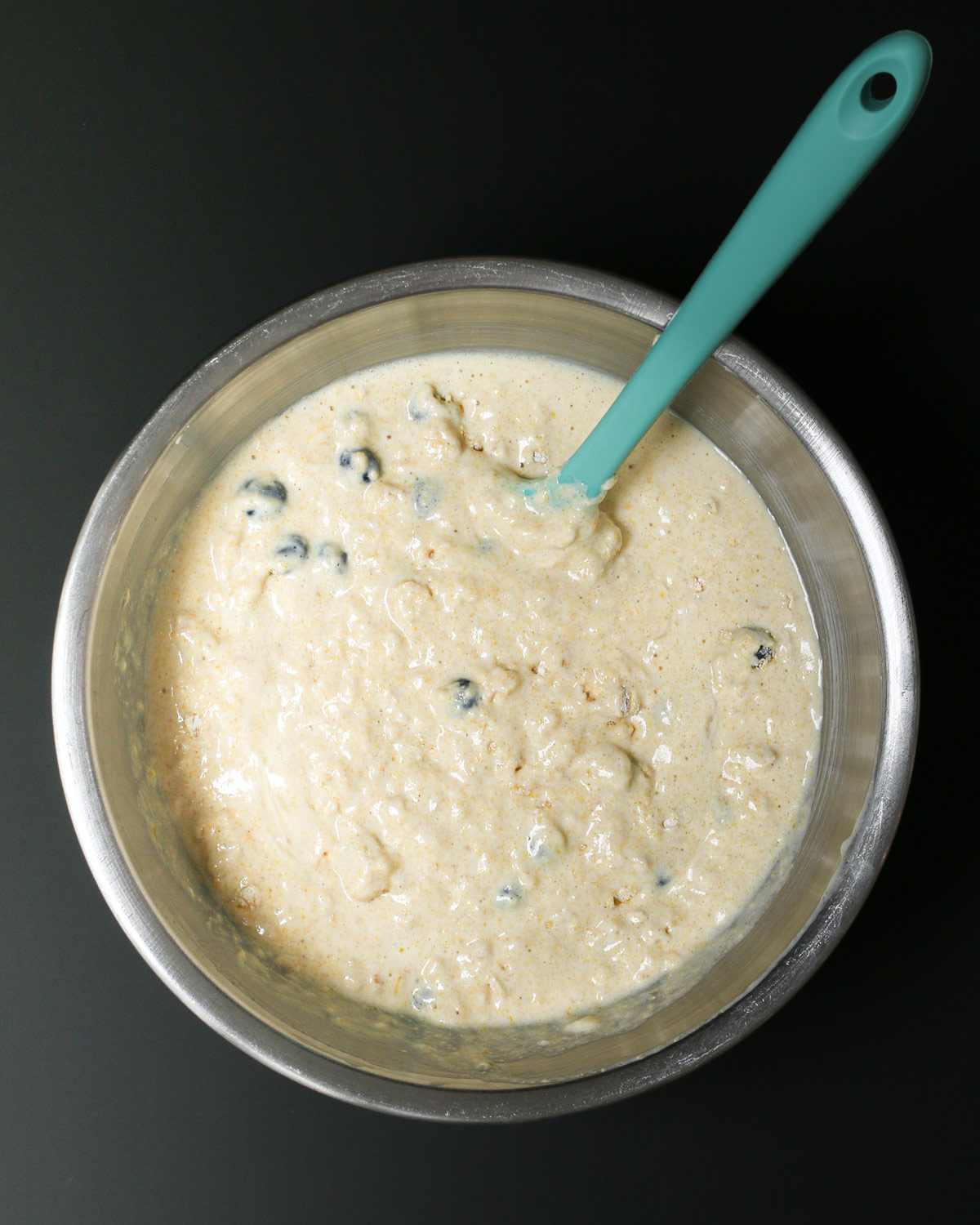 teal spatula submerged in the mixed batter.