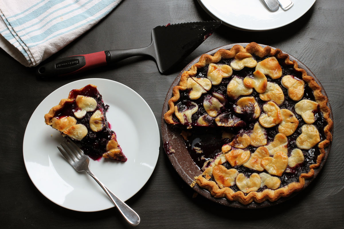 blueberry pie and slice on table