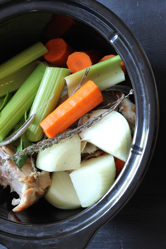vegetables and turkey stock ingredients in slow cooker
