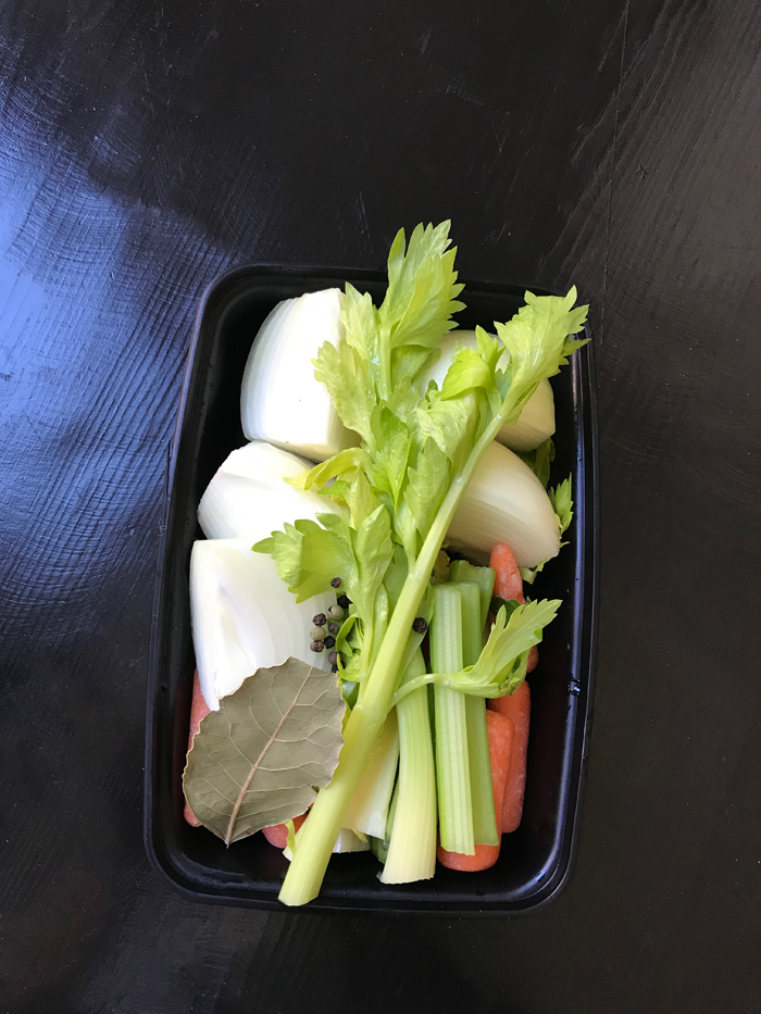 food storage box with aromatics and vegetables to make stock