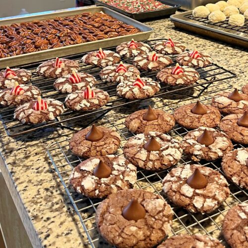 trays of christmas cookies and candies on counter.