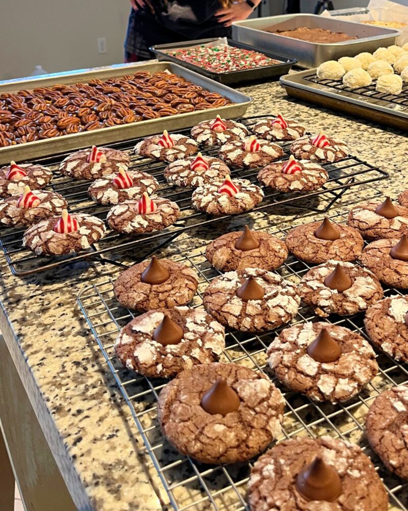 trays of christmas cookies and candies on counter.