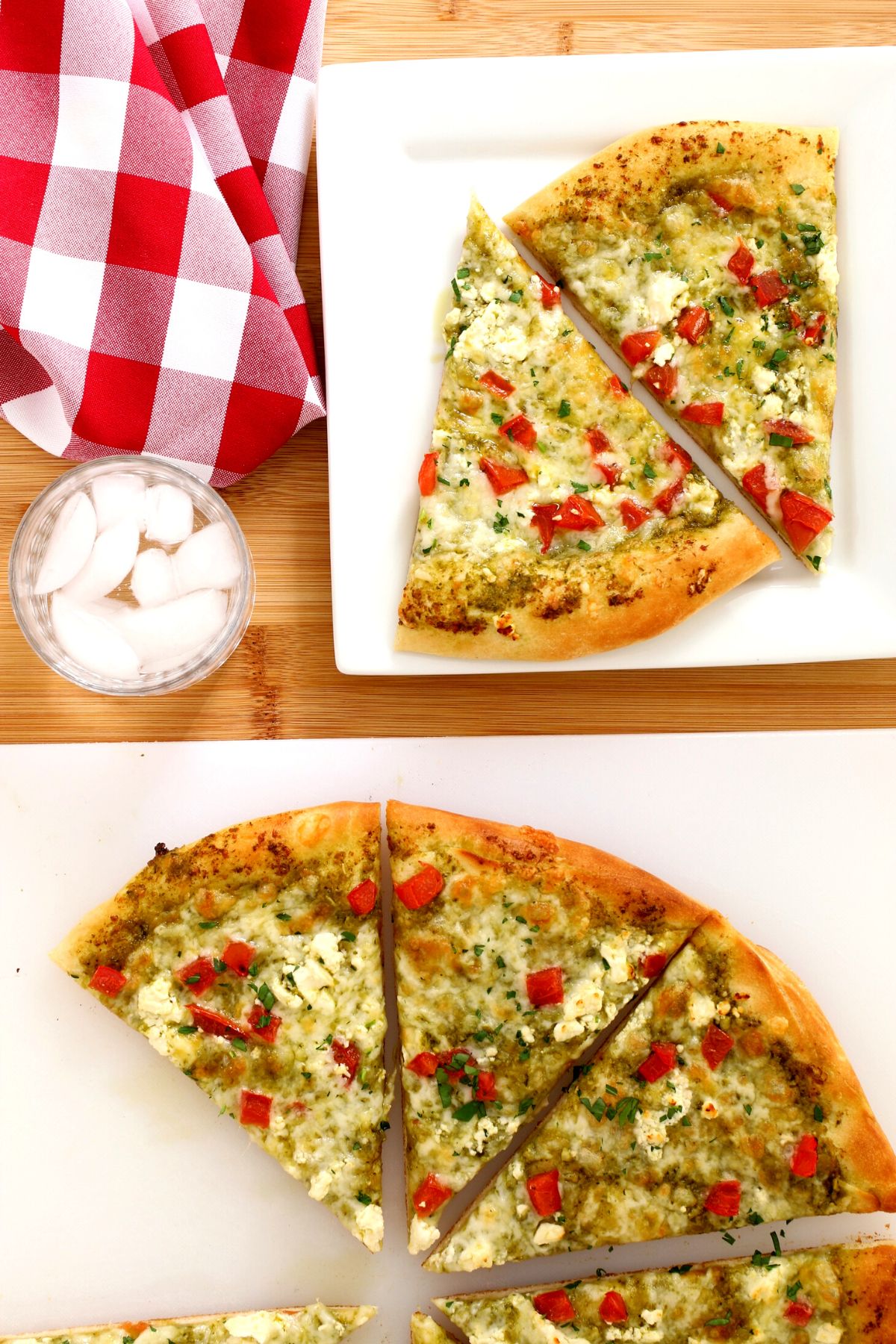 pesto pizza dished up on a square plate with a whole pizza sliced on cutting board.