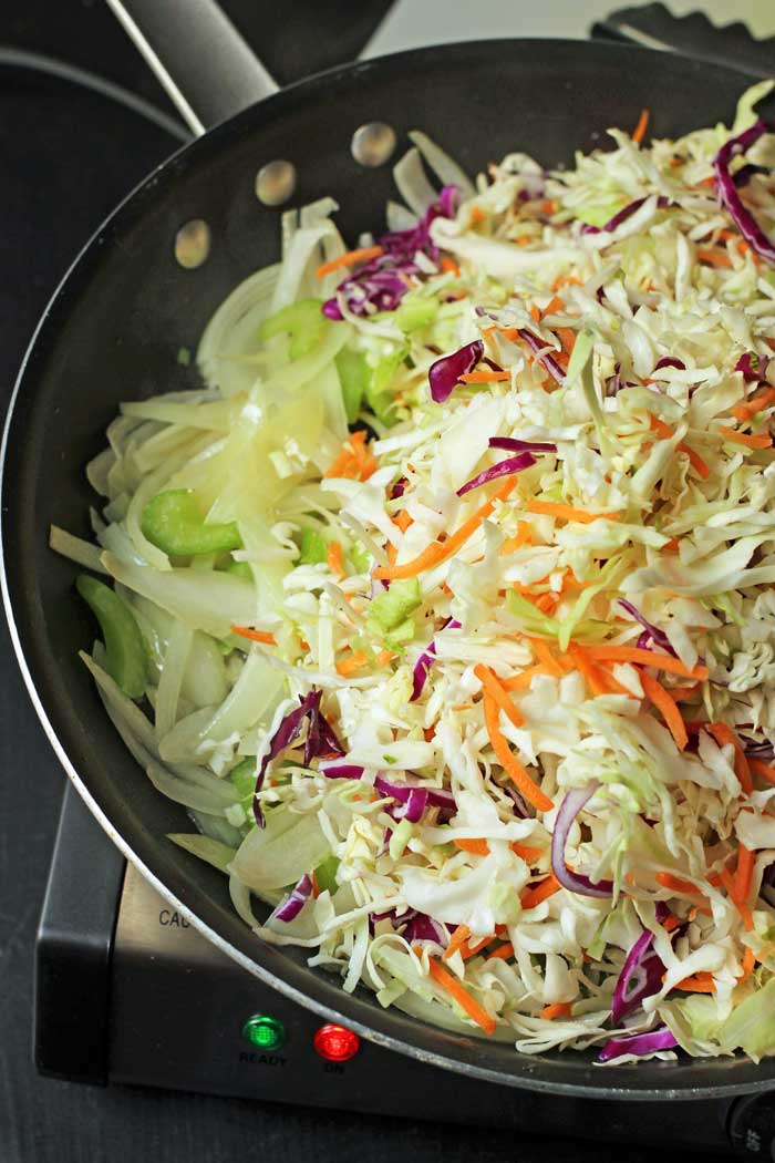 adding coleslaw to skillet