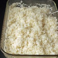 baked rice in baking dish with fork
