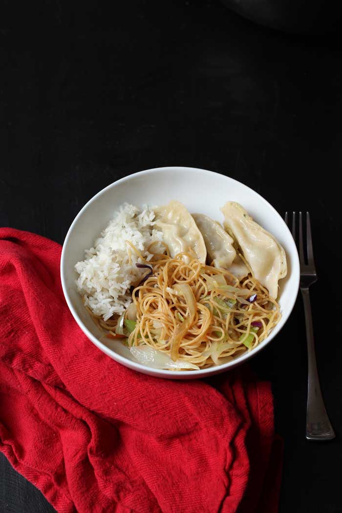 bowl of chow mein, rice, and potstickers