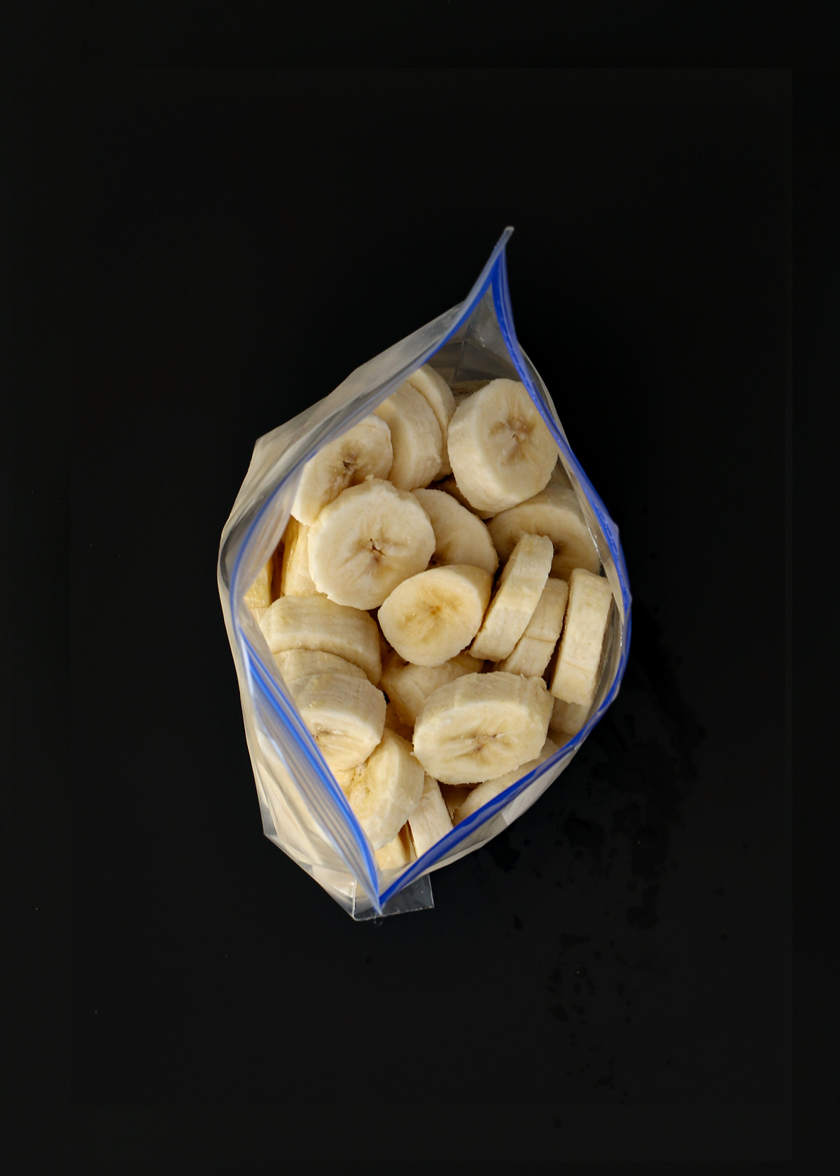 sliced bananas in open ziptop bag.