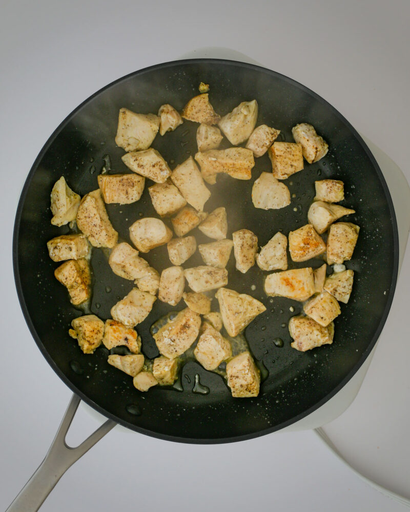 cooking chicken in a skillet.