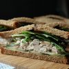 cut side view of chicken salad sandwich with cucumber