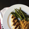 chicken breast on a plate with green beans and rice