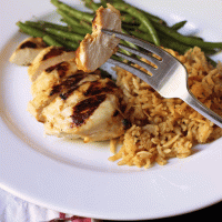 dinner plate with bite of chicken on the fork