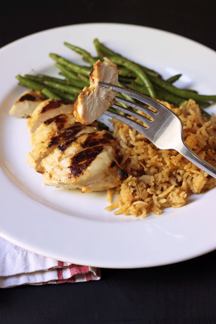 dinner plate with bite of chicken on the fork