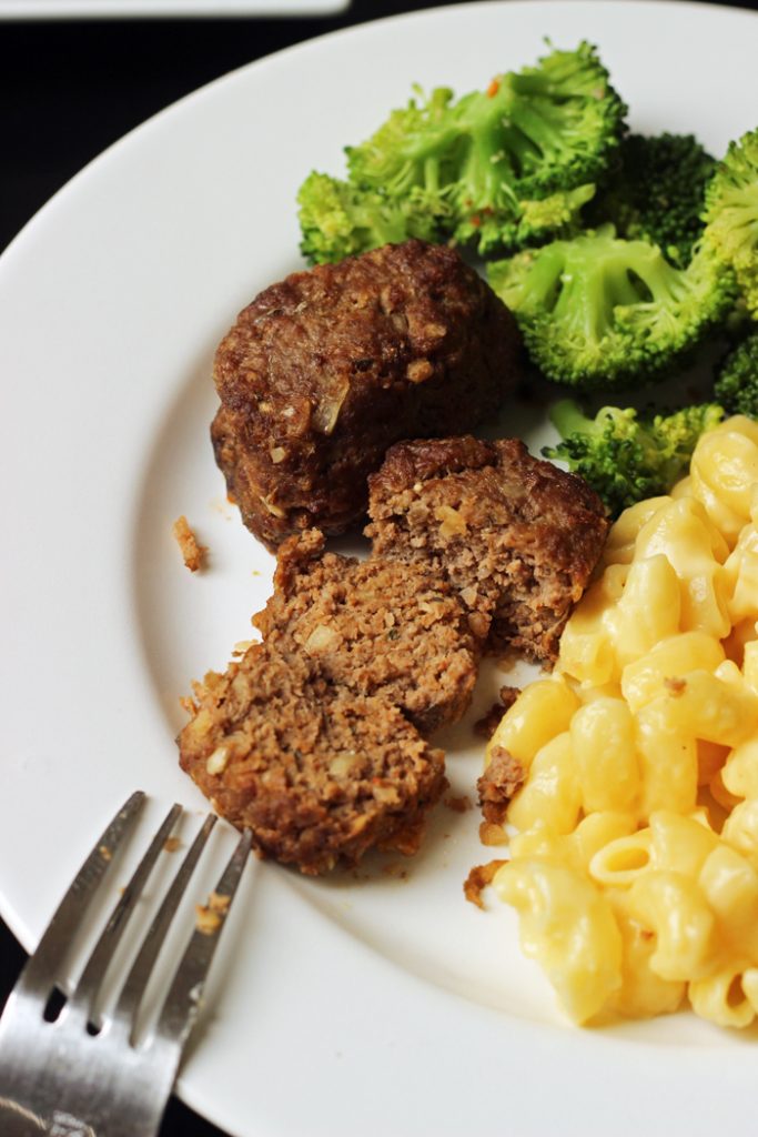 mini meatloaf cut into slices with macaroni and broccoli