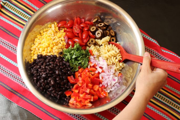 A bowl of pasta, black beans, and vegetables