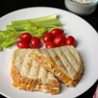 A plate of veggies, with Buffalo Tuna Melt Sandwich