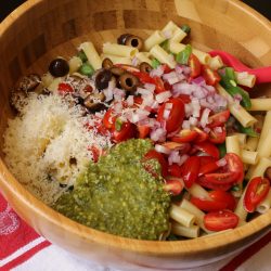 A bowl of pesto pasta salad ingredients