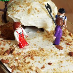 cake of an empty tomb with plastic figurines
