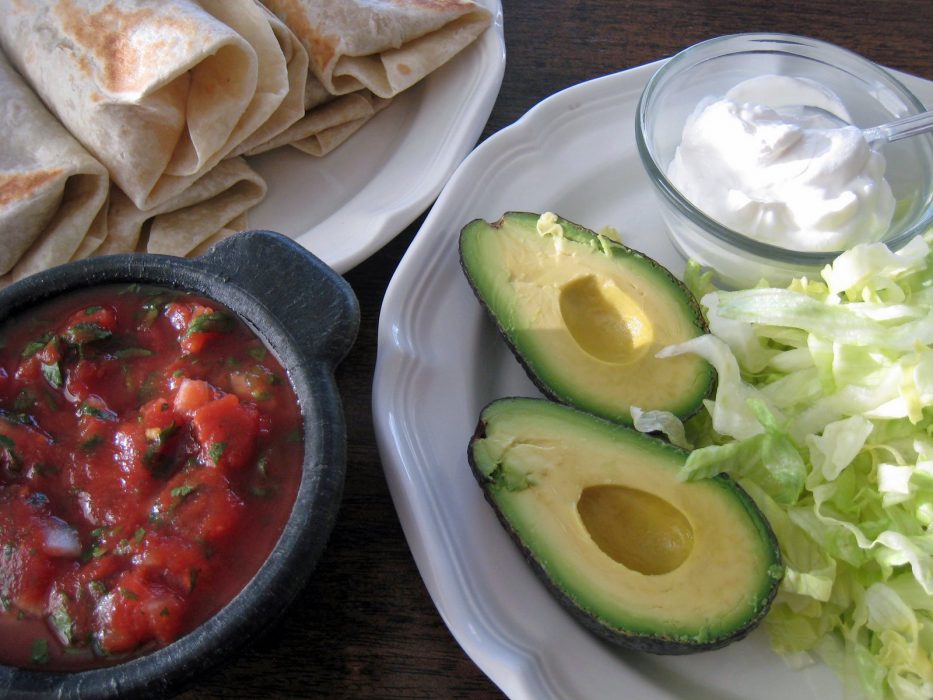 platter of burritos, with avocados and salsa