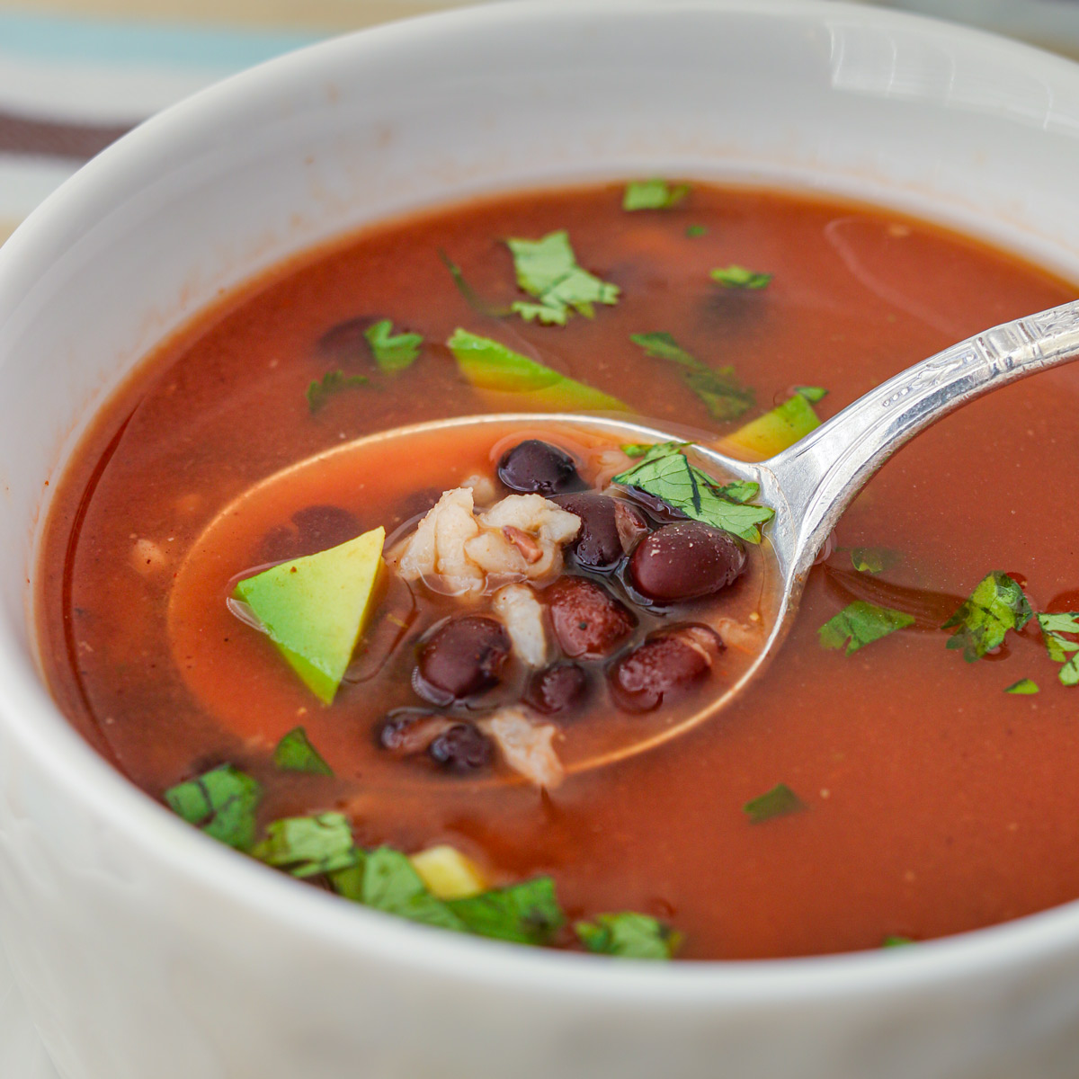 side view of soup on spoon.