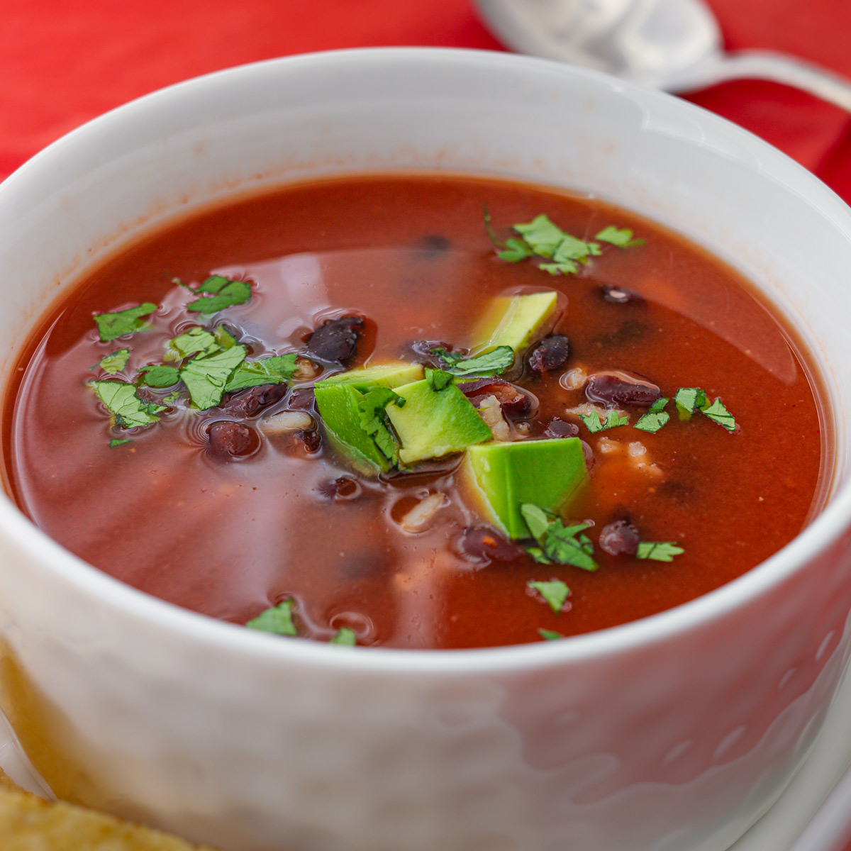 bowl of bean and rice soup with toppings.