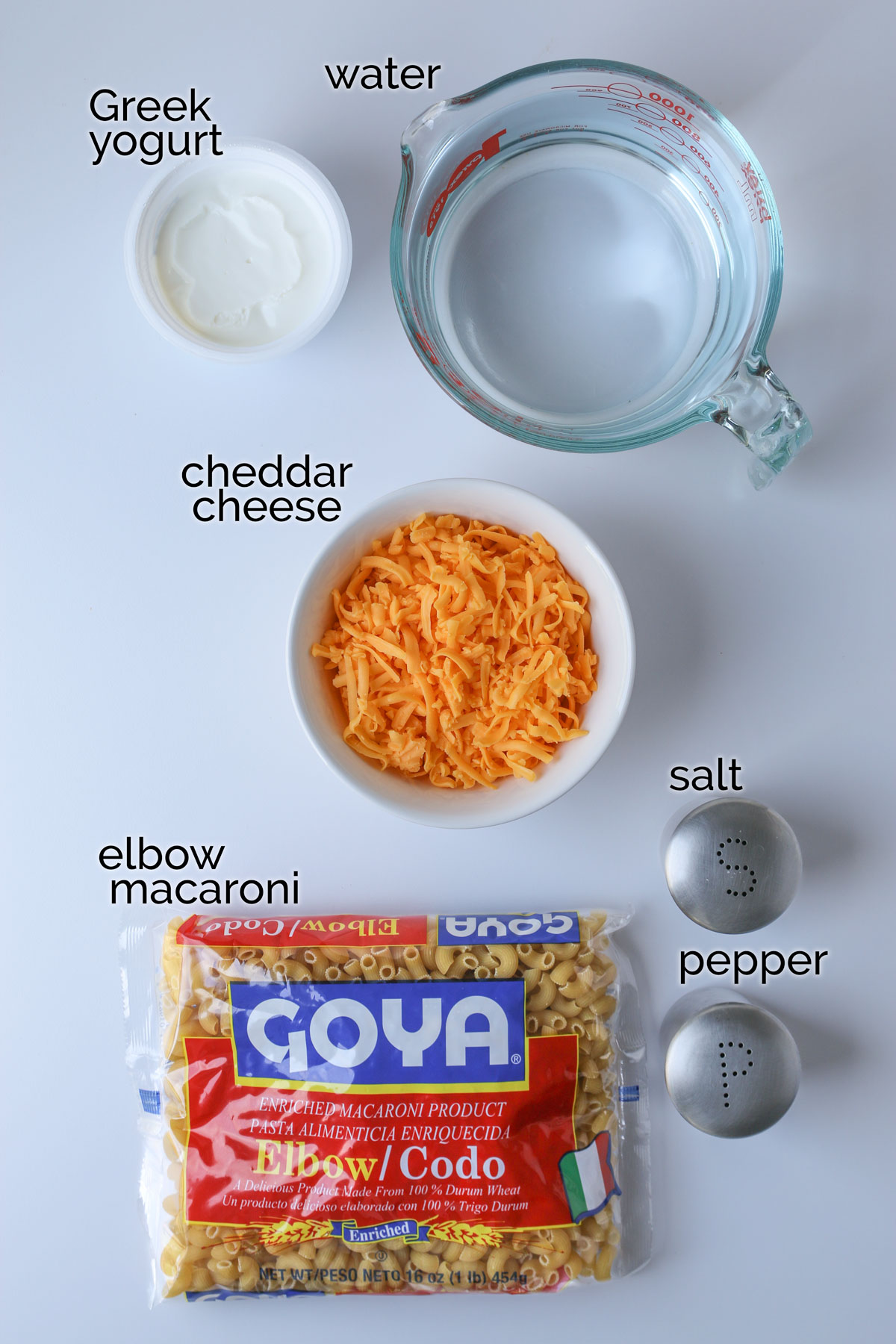 ingredients for instant pot mac and cheese laid out on white counter.
