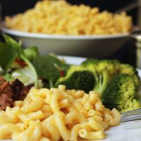 close up of macaroni on plate with large bowl