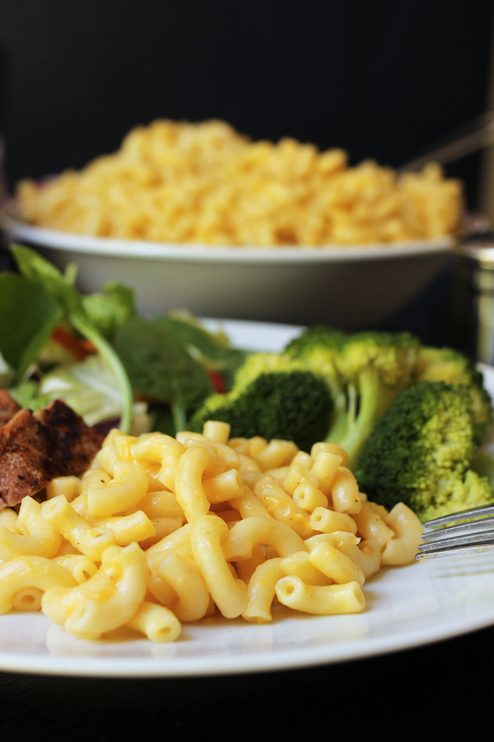 close up of macaroni on plate with large bowl