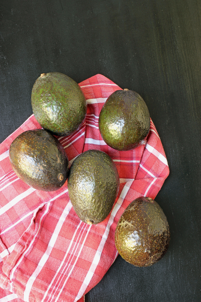 pile of avocados with red cloth