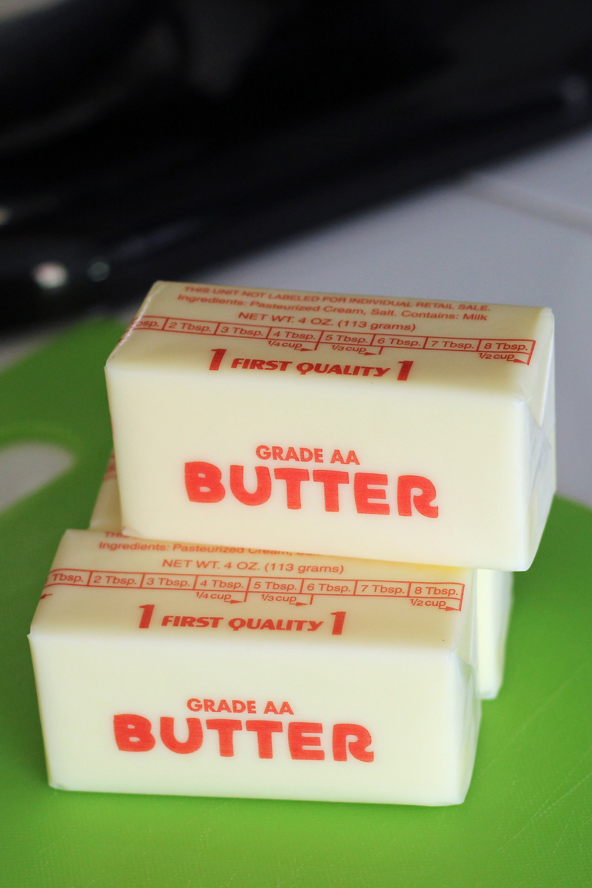 stack of butter sticks softening on countertop.