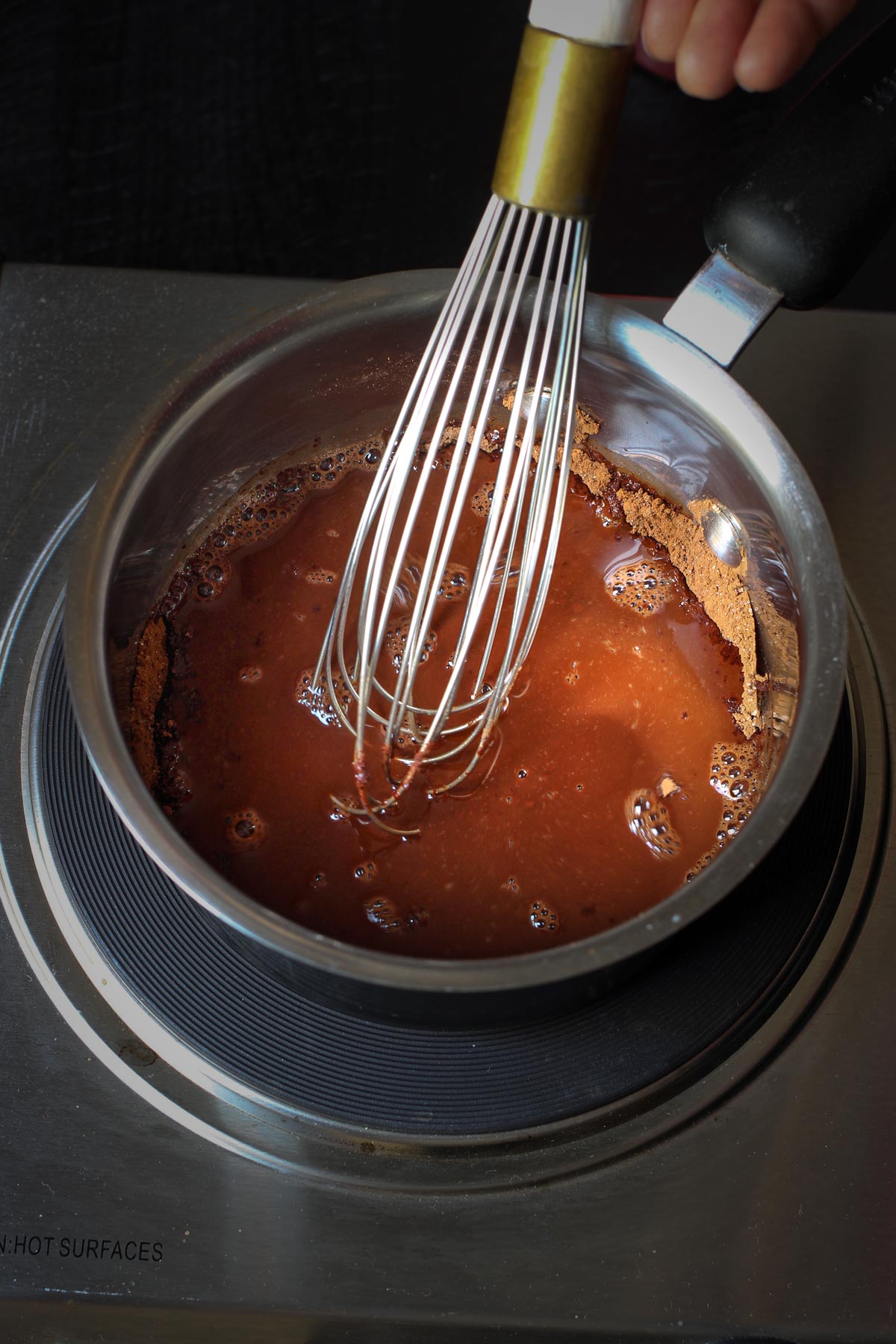 whisking the cocoa water mixture over the heat.
