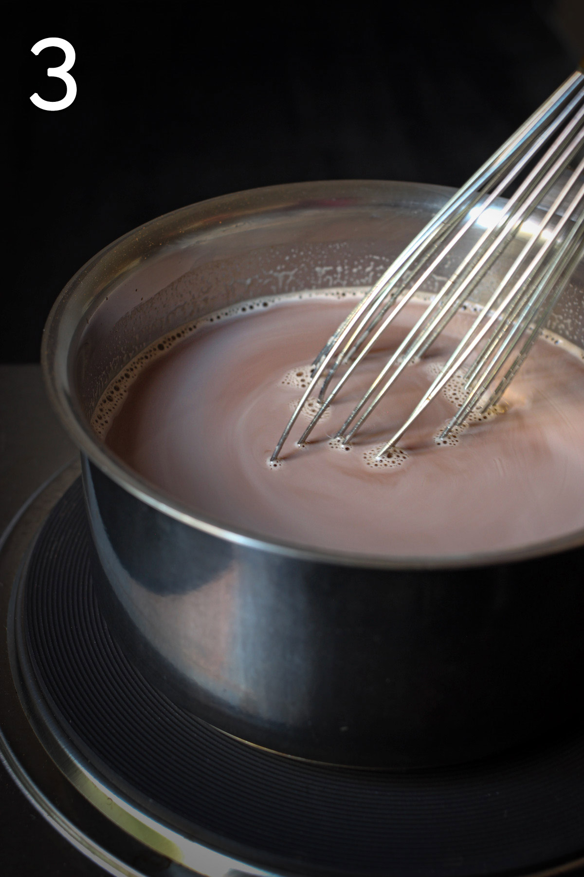 milk added to the pan and whisking.