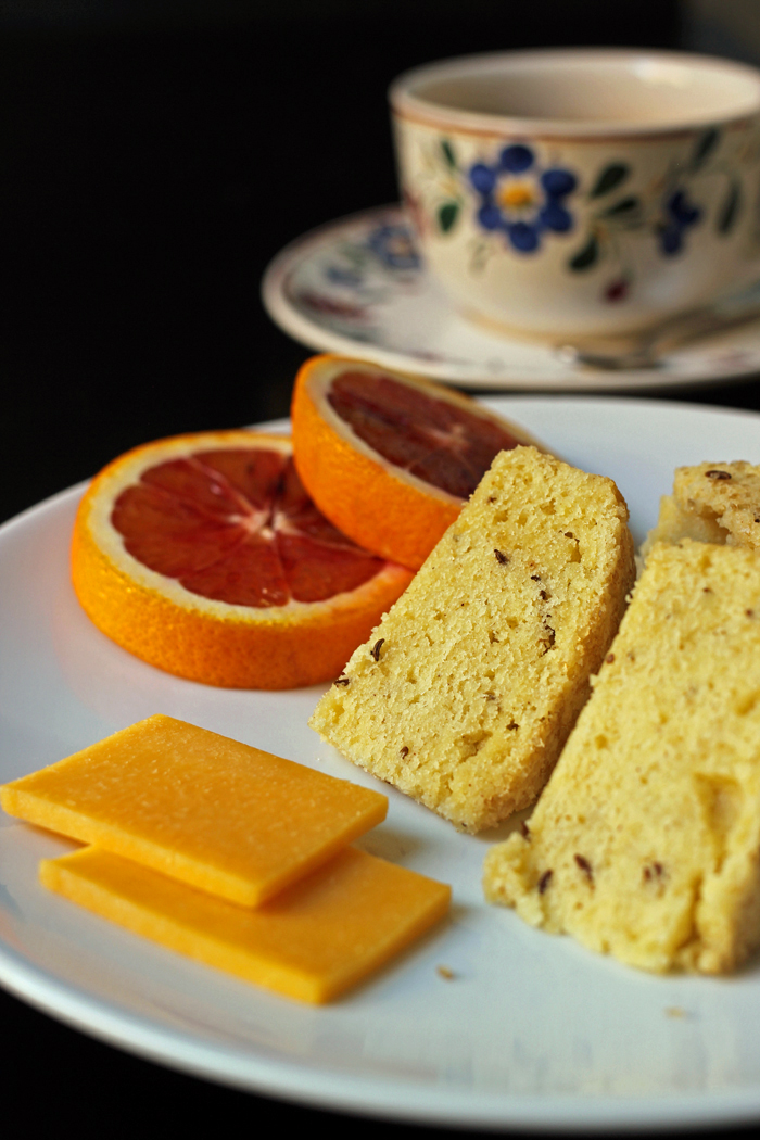 A close up of a plate of seed cake with Fruit and Tea