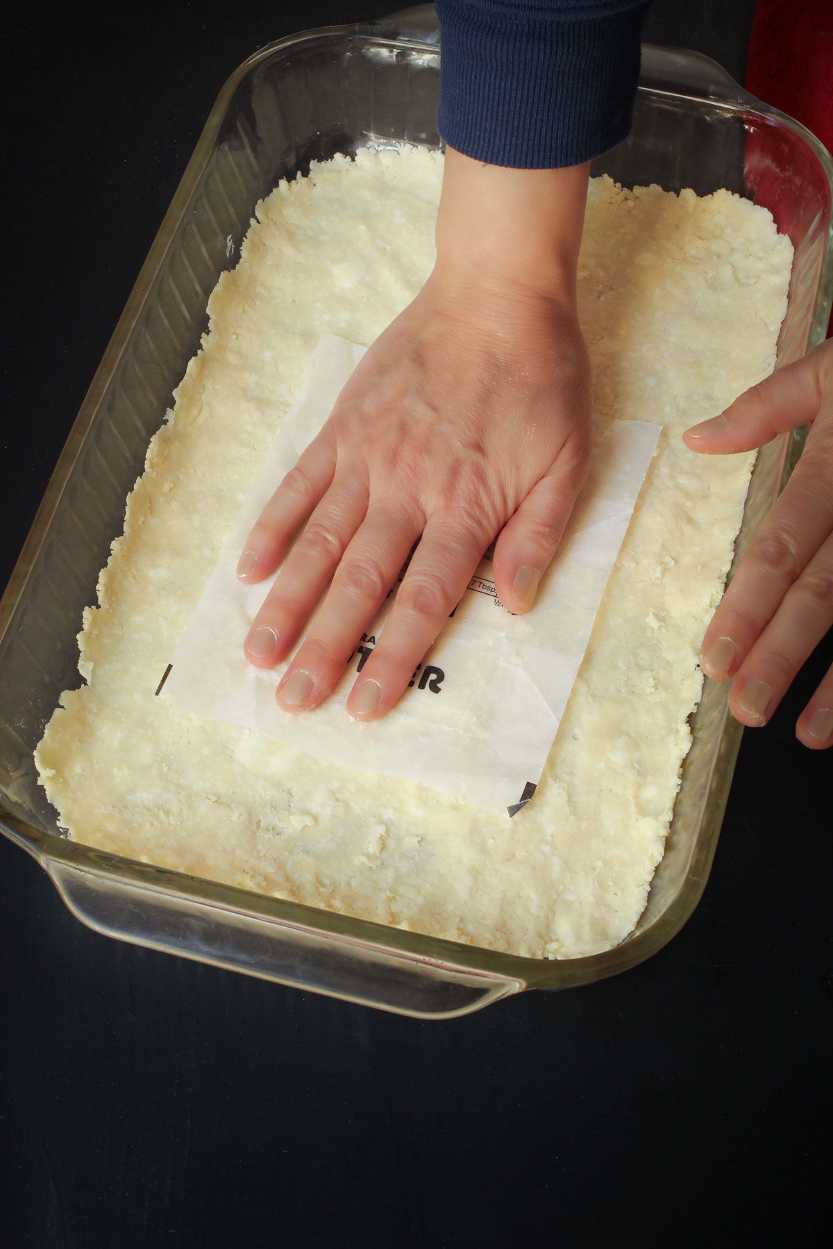 pressing crumbs into the bottom of the pan with a butter wrapper.