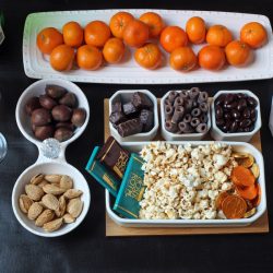 dessert table with fruit nuts chocolate and popcorn