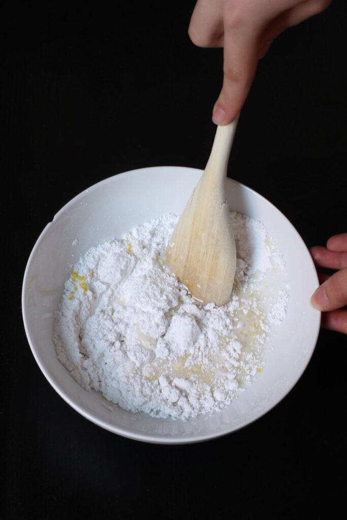 stirring glaze ingredients with a wooden spoon.