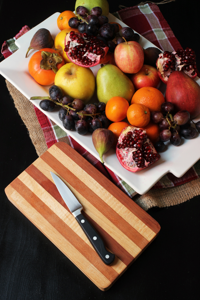 platter of fruit with cutting board and knife