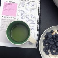 breakfast bowl with tea and planner