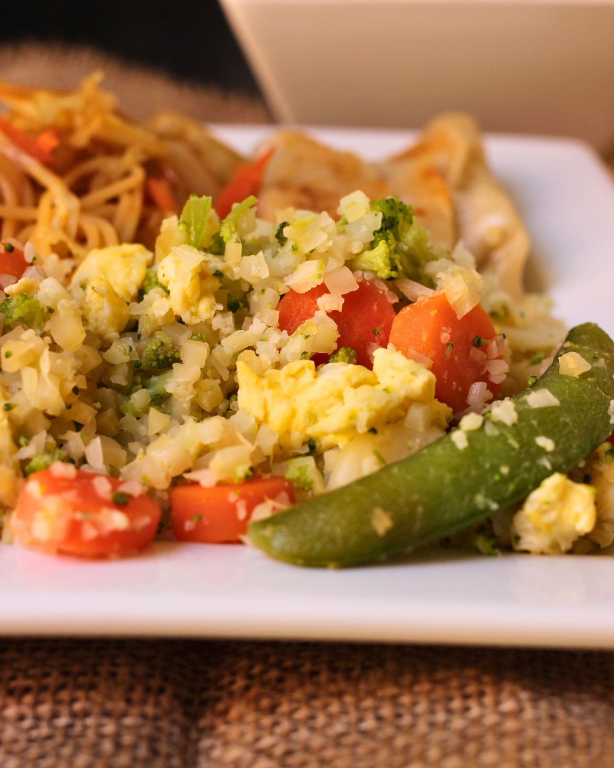 a close up view of the cauliflower rice stir fry on plate.