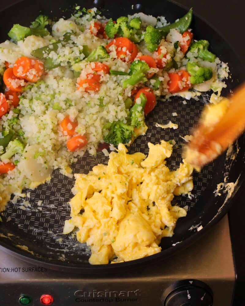 scramble the eggs in the empty side, while keeping the veggies warm on one side.
