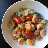 shrimp bowl with tomatoes peas and cauliflower rice
