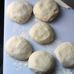 sourdough pizza dough balls on cutting board