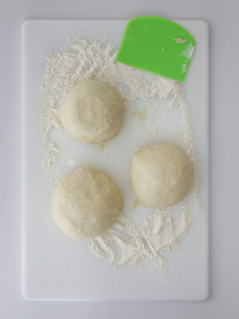 smaller dough balls formed on the cutting board.